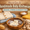 Hand washing handmade baby knitwear in a wooden bowl with folded knitted baby sweaters, natural detergent, and soft baby accessories arranged on a rustic background.