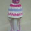 STRIPE EARFLAP WITH NAME BOWS AND POMPOM
